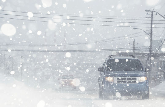 Image of car driving in snowy conditions