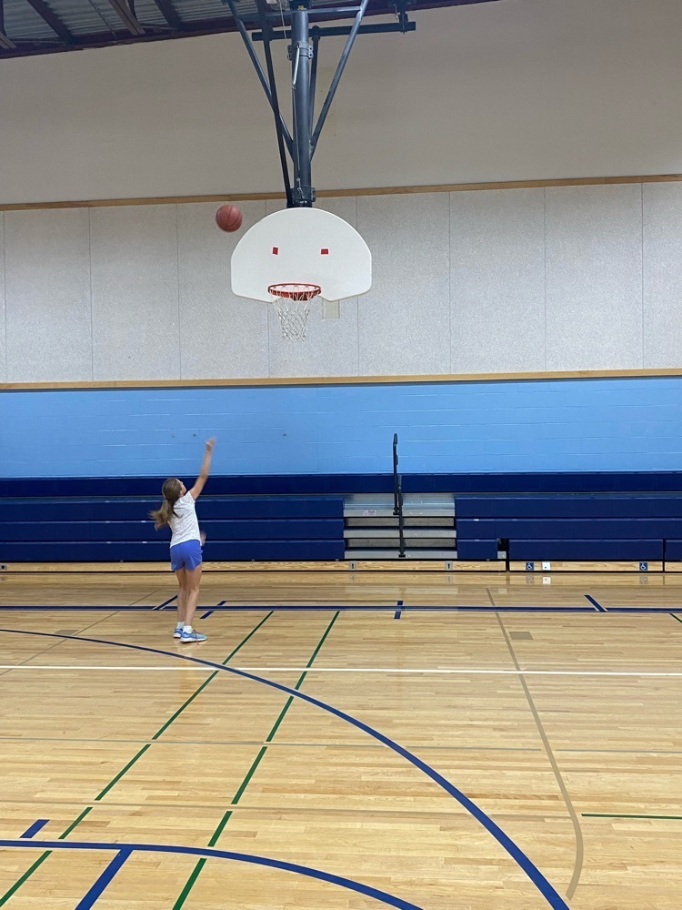 girl throwing basketball 