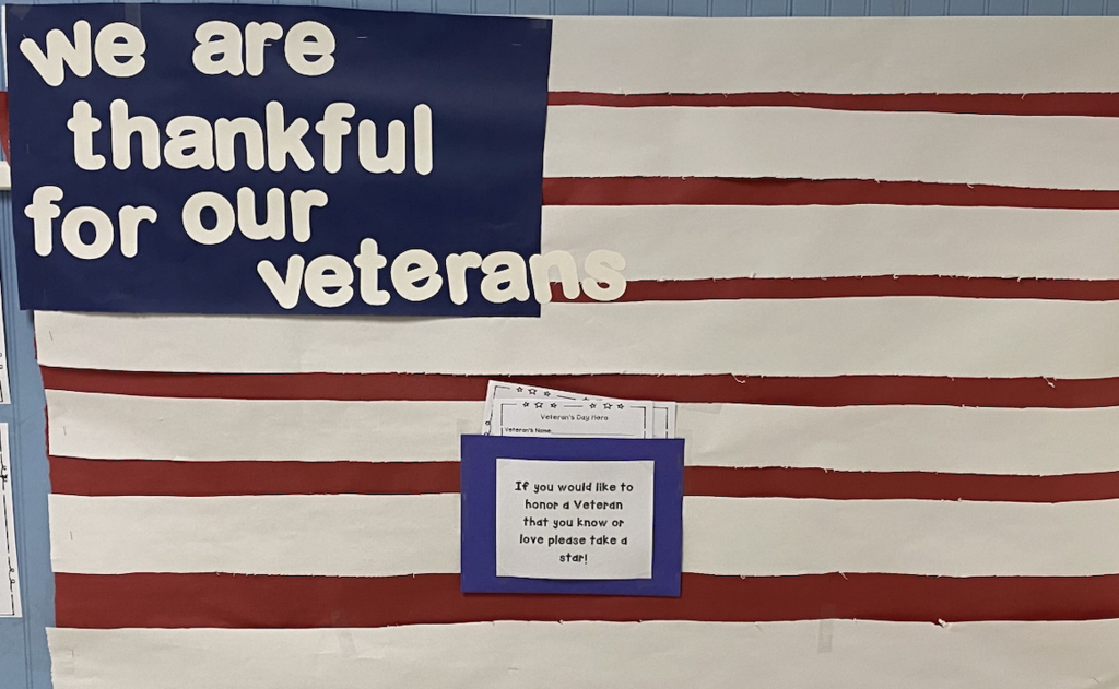Image of a hand created paper flag with the words we are thankful for our veterans